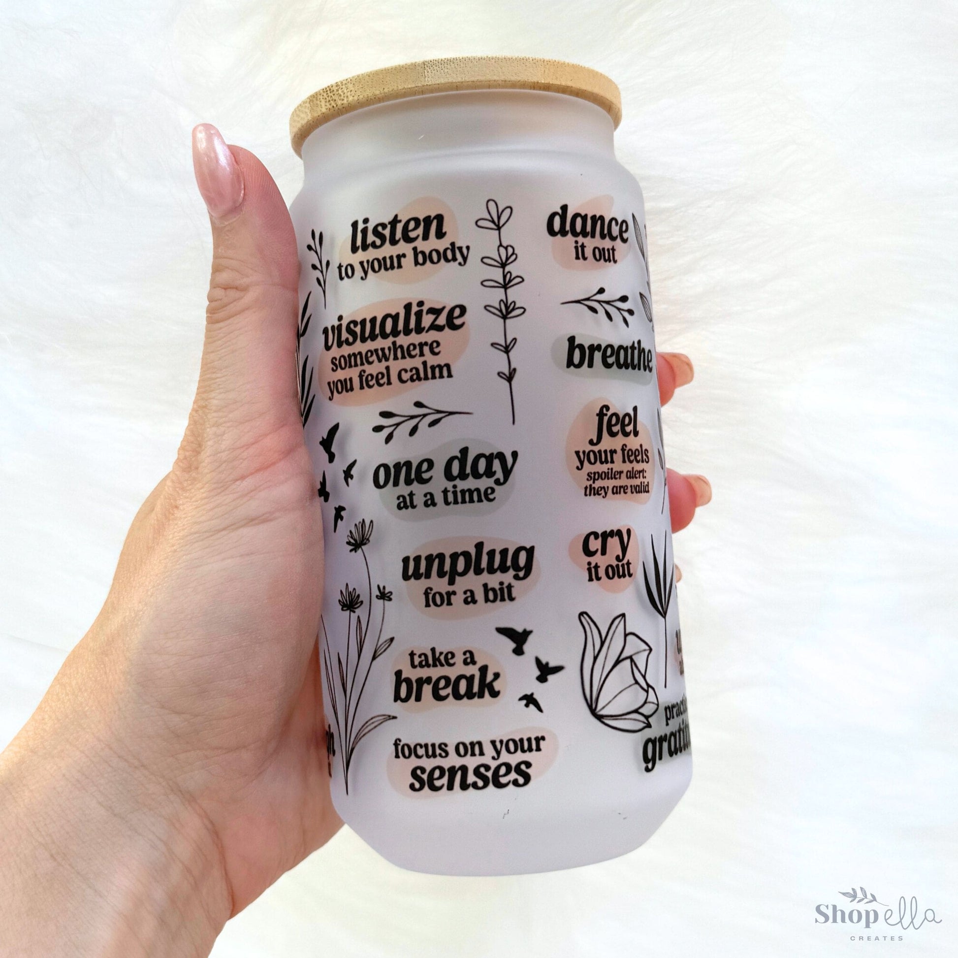 a hand holding a white can with words on it