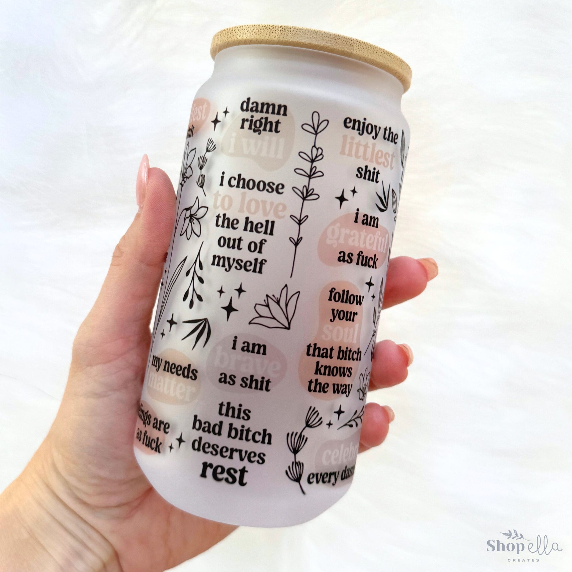 a hand holding a can of beer with words on it