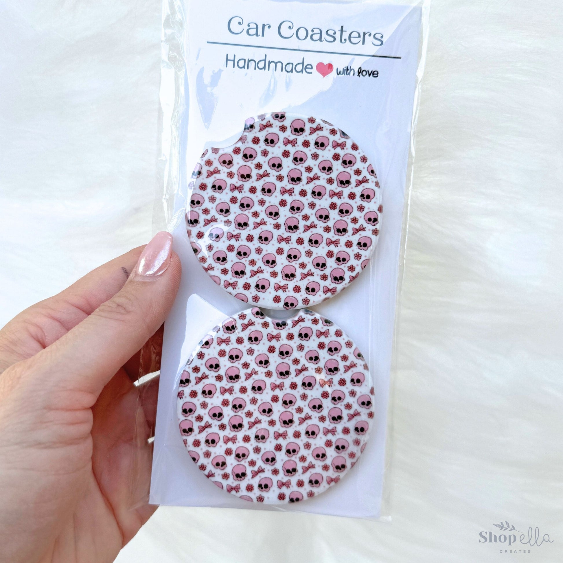 a package of car coasters in a package pink skulls and bows