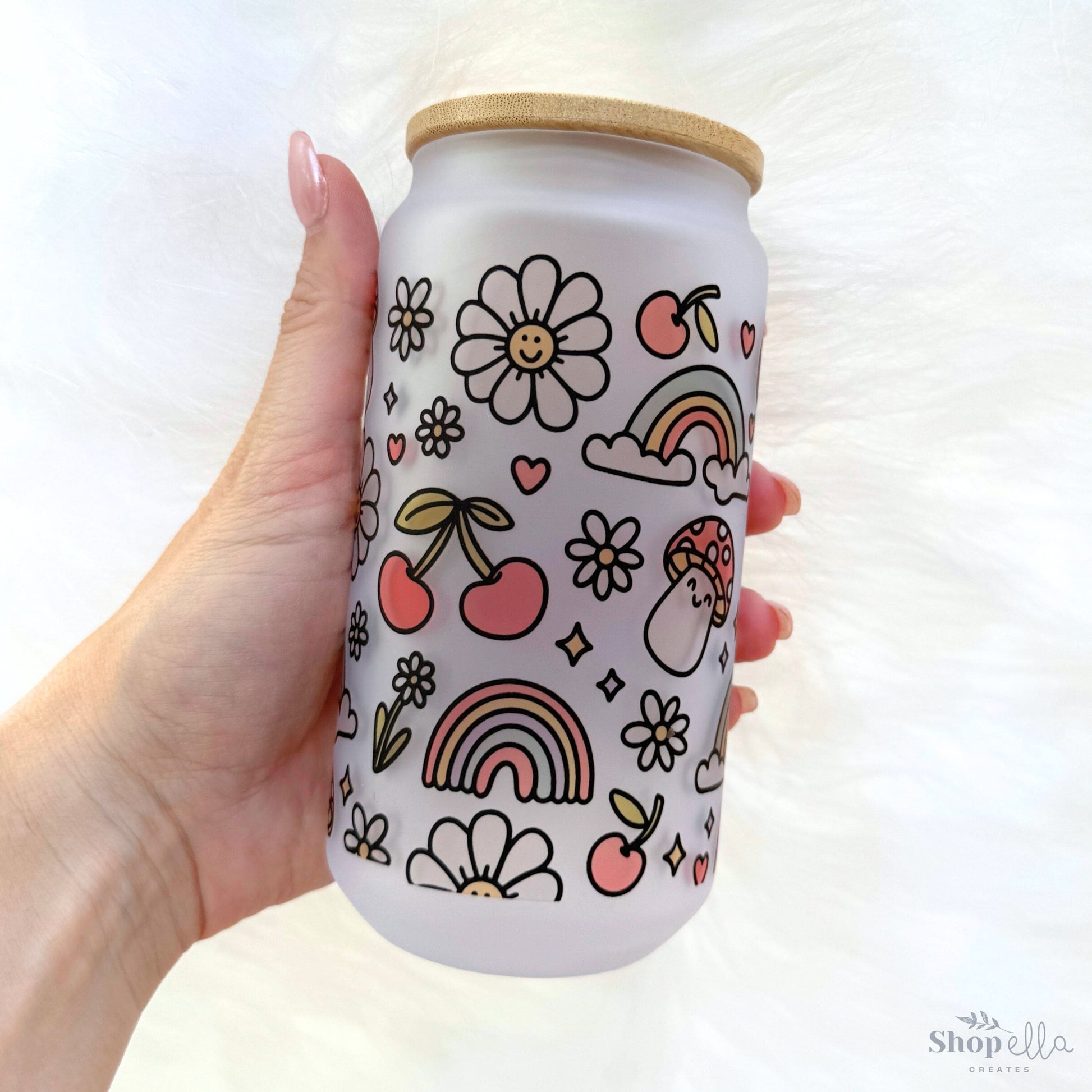 a hand holding a can with a pattern on it