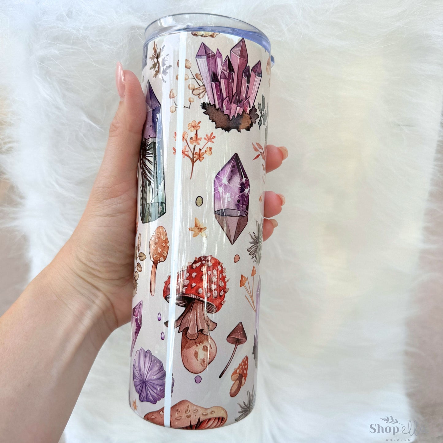 a person holding a cup with a pattern on it