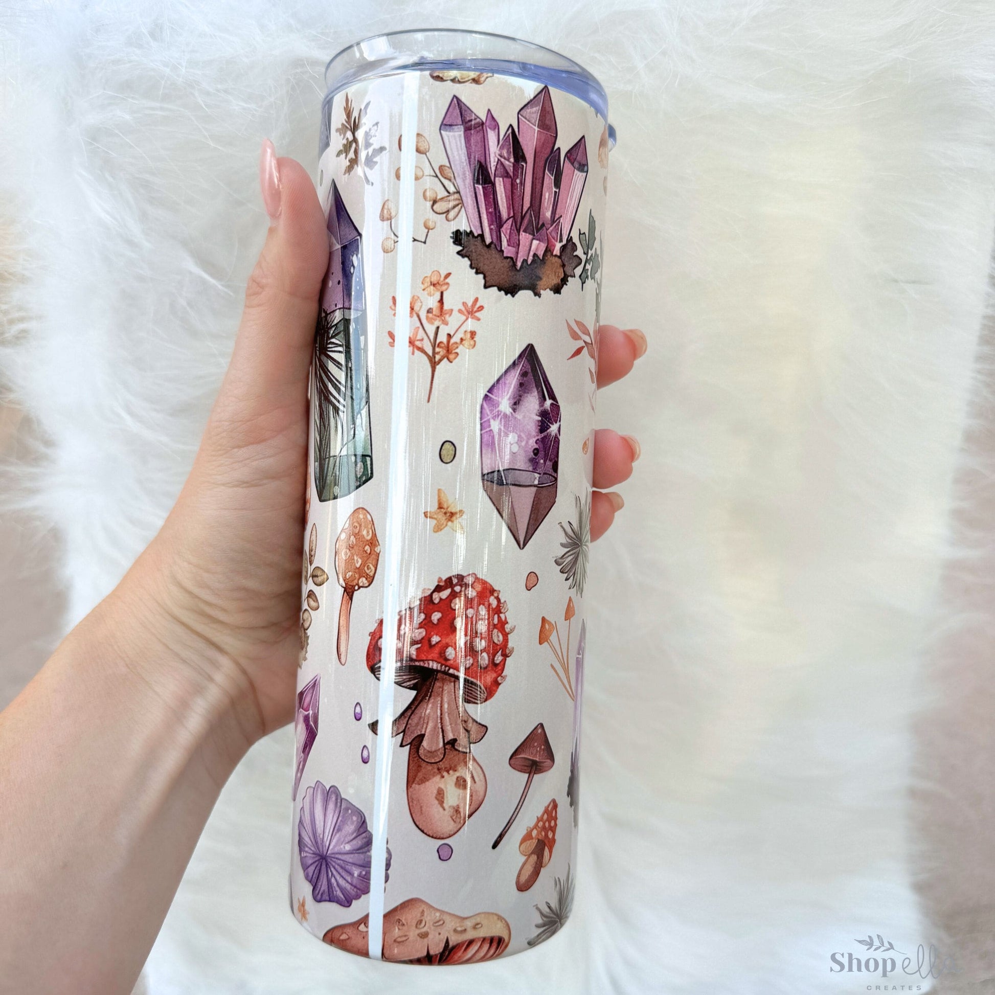 a person holding a cup with a pattern on it
