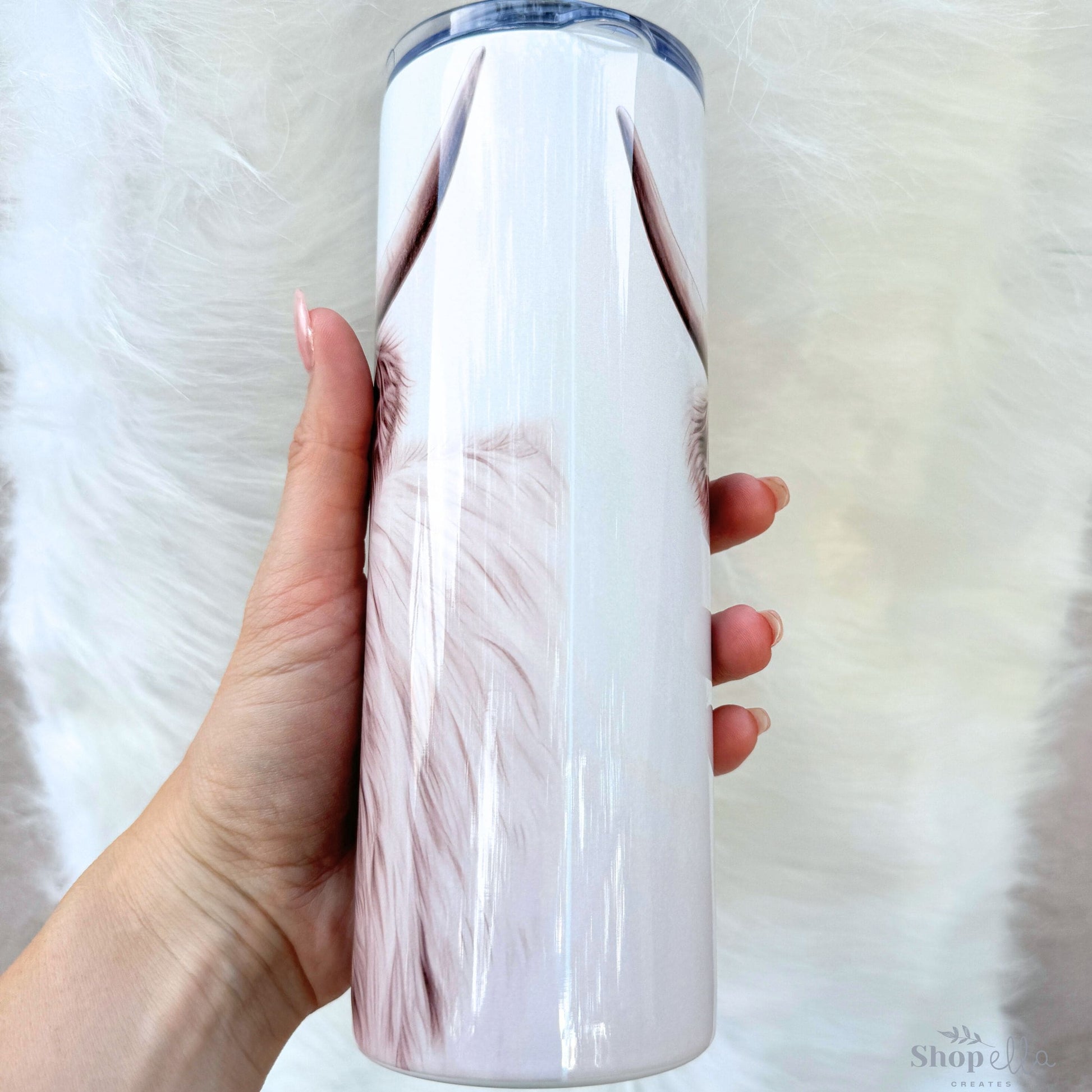 a woman holding a white and pink water bottle