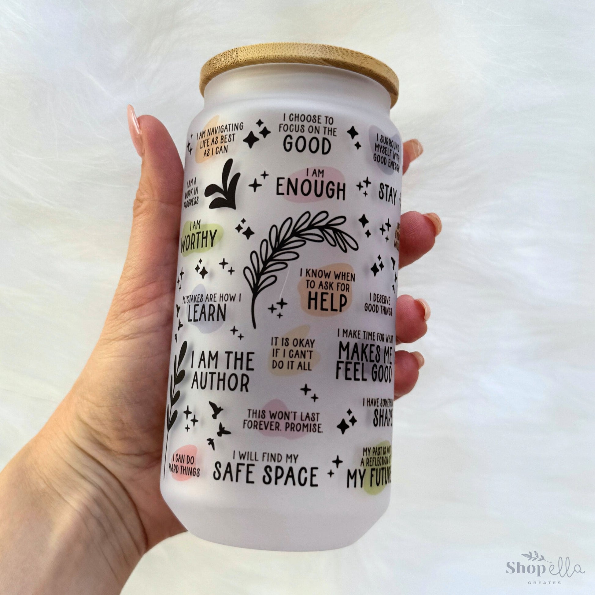 a hand holding a white can with words all over it