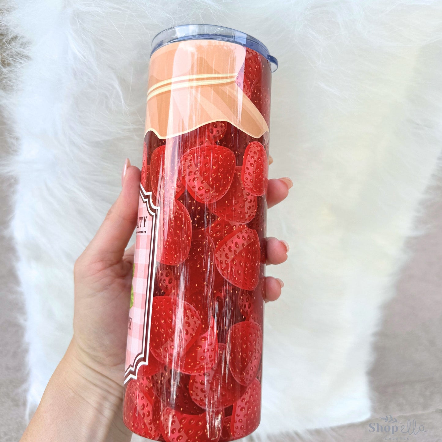 a woman holding a can of strawberries in her hand