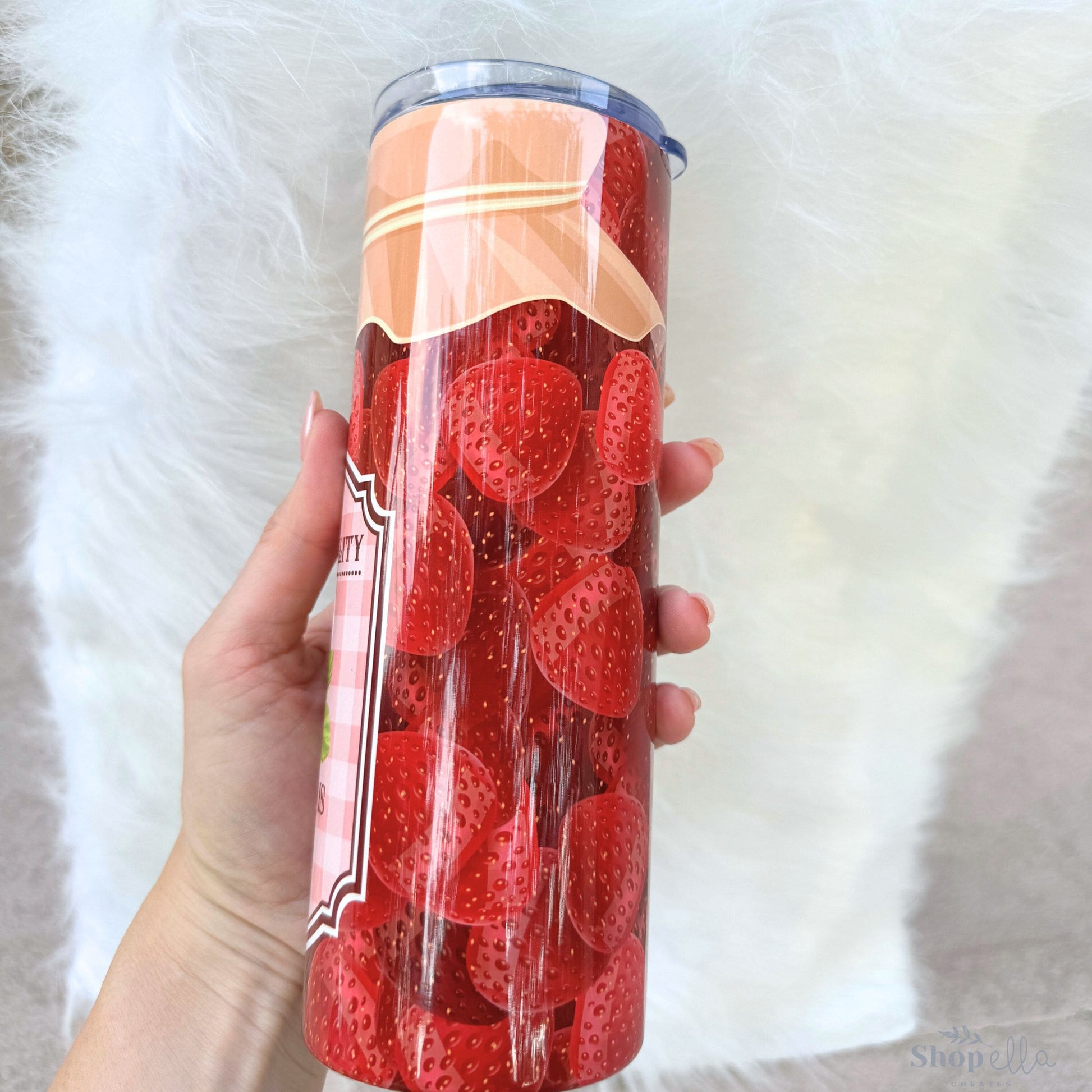 a woman holding a can of strawberries in her hand