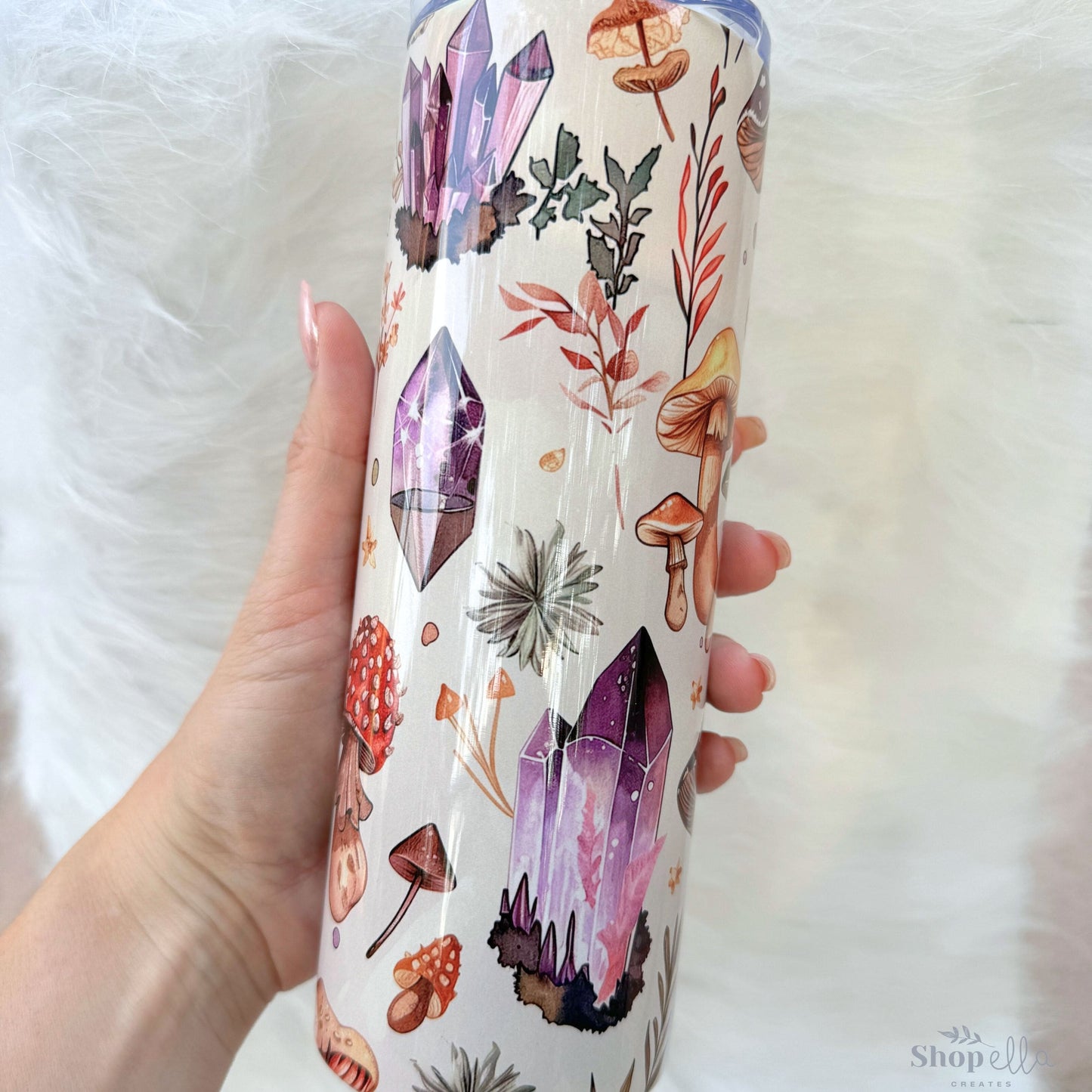 a person holding a cup with a pattern on it