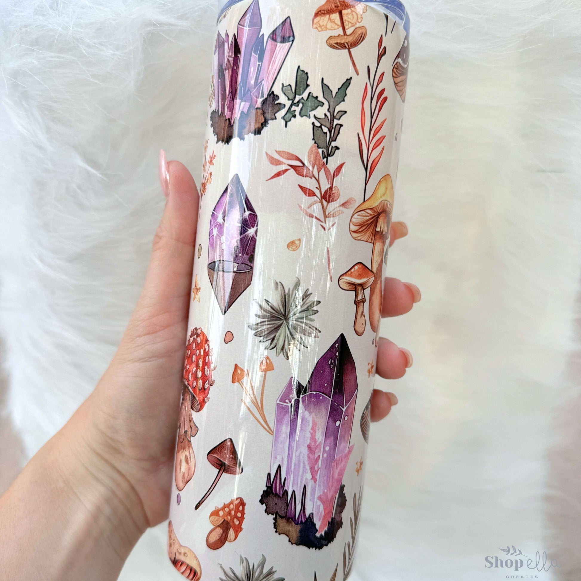 a person holding a cup with a pattern on it