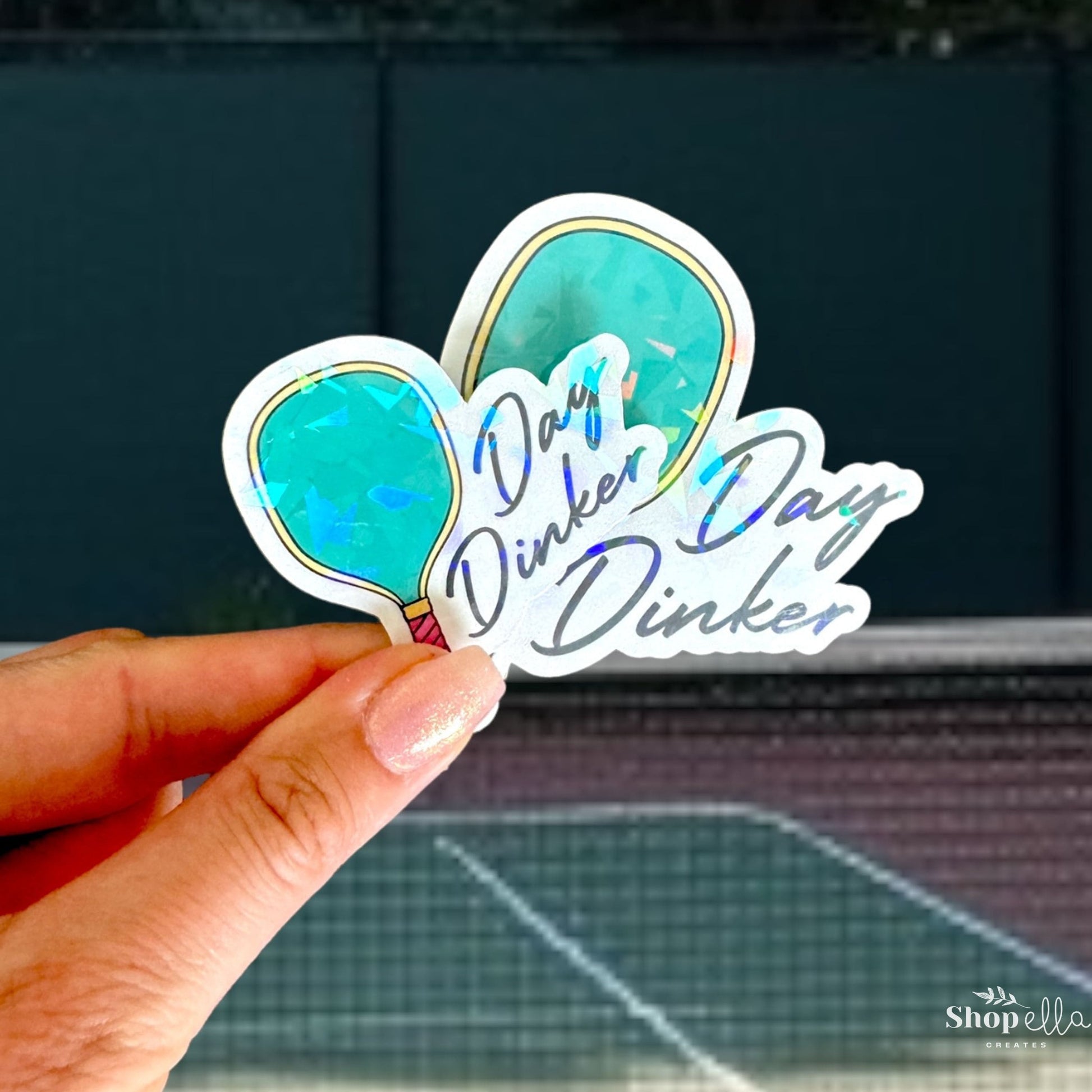 a person holding up a sticker with a picture of a butterfly on it