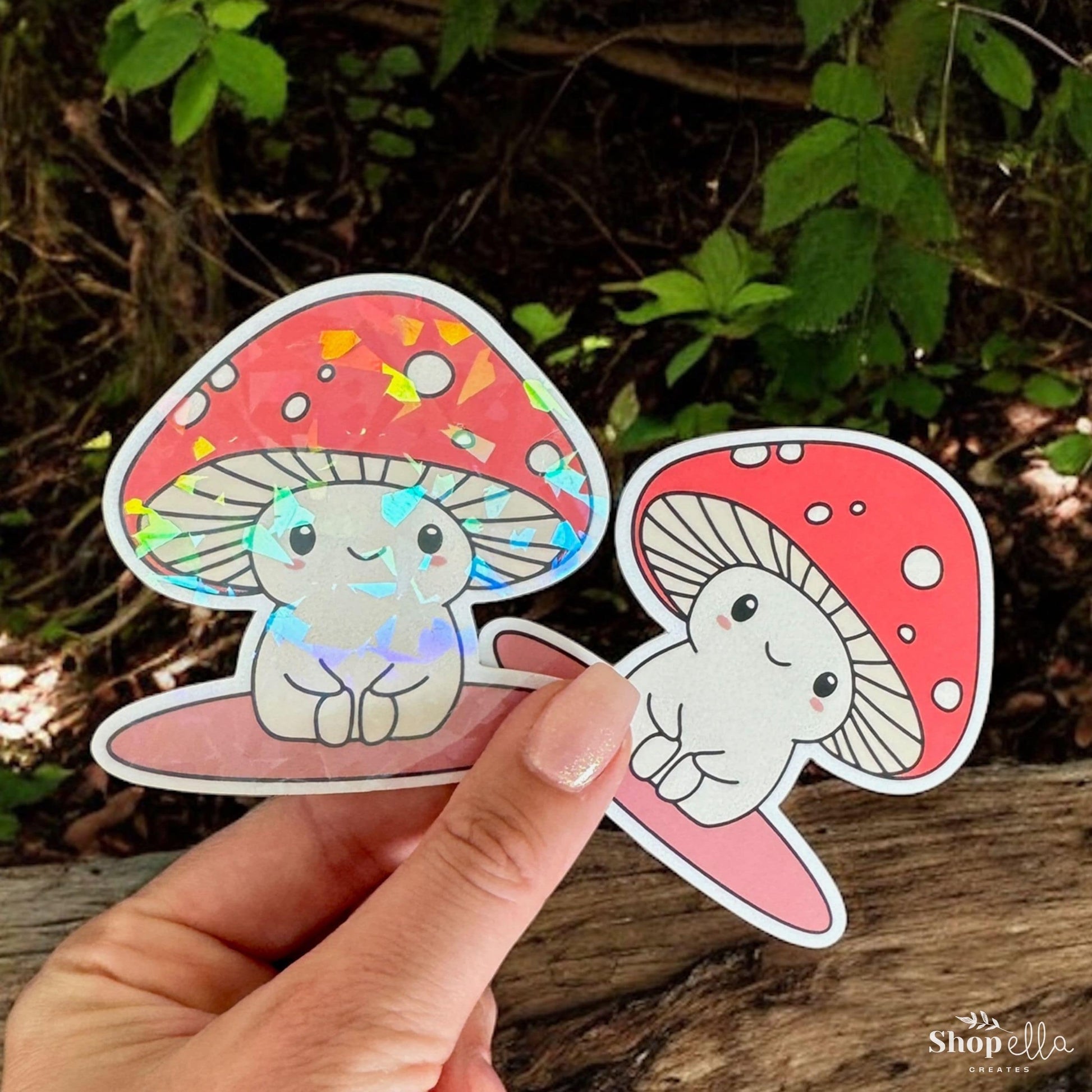 a hand holding a sticker of a mushroom