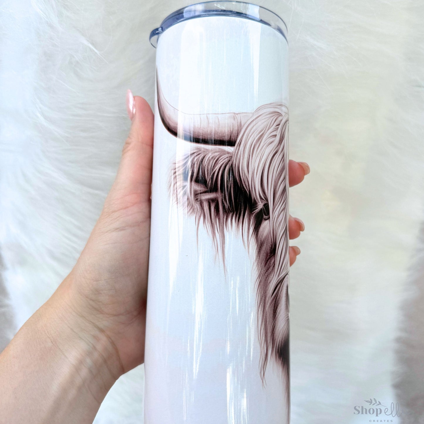 a woman holding a white cup with a picture of a dog on it