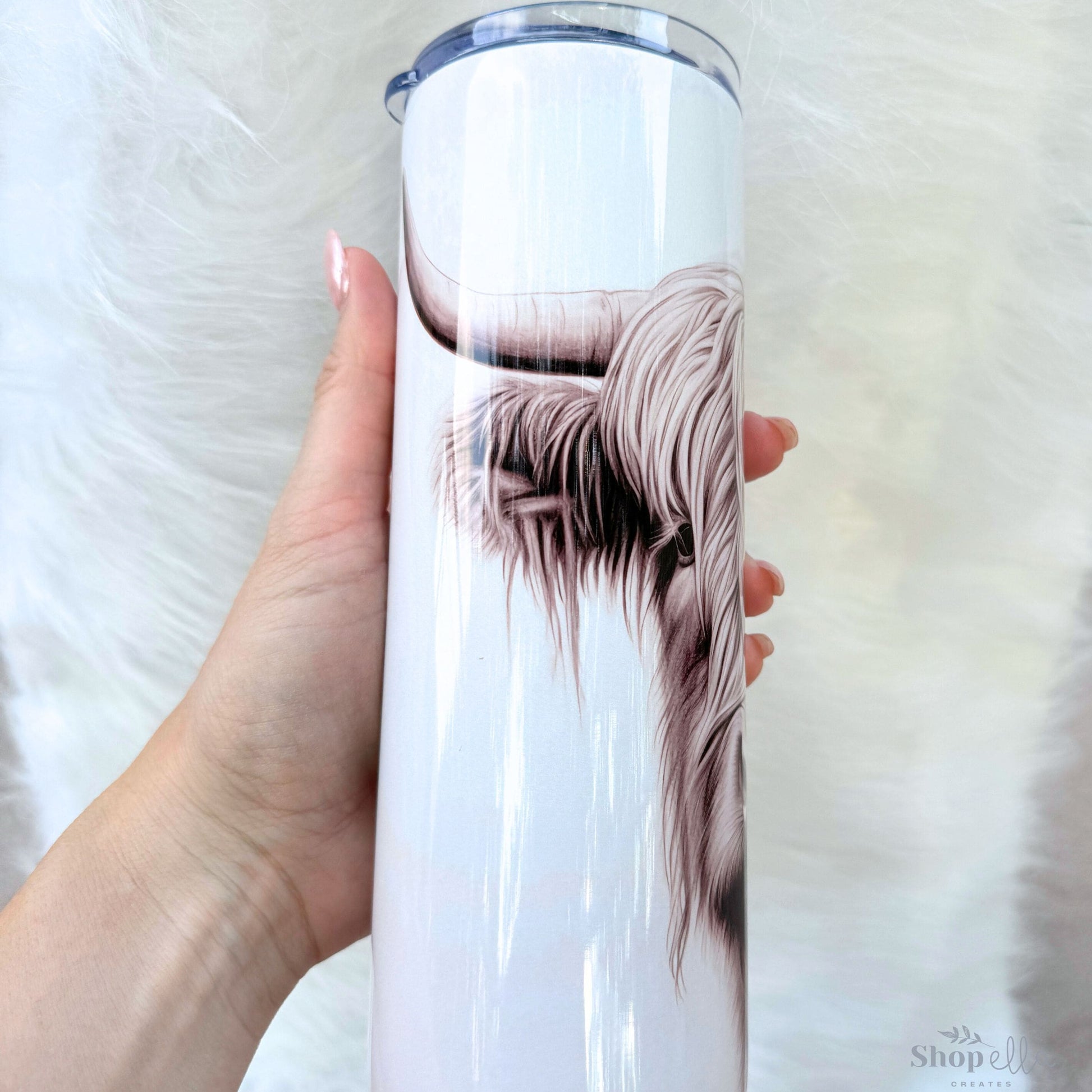 a woman holding a white cup with a picture of a dog on it