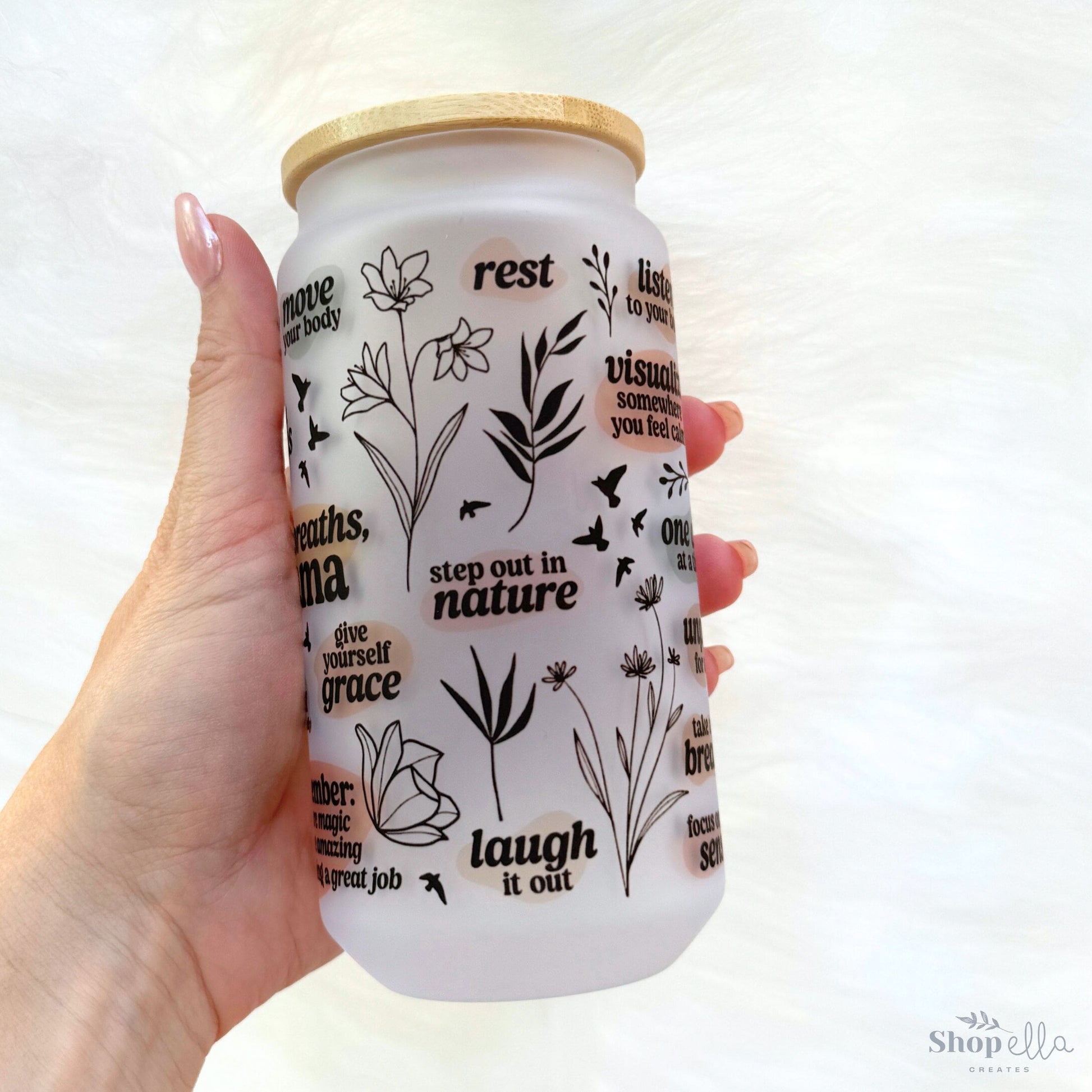 a hand holding a jar of liquid that says rest in nature
