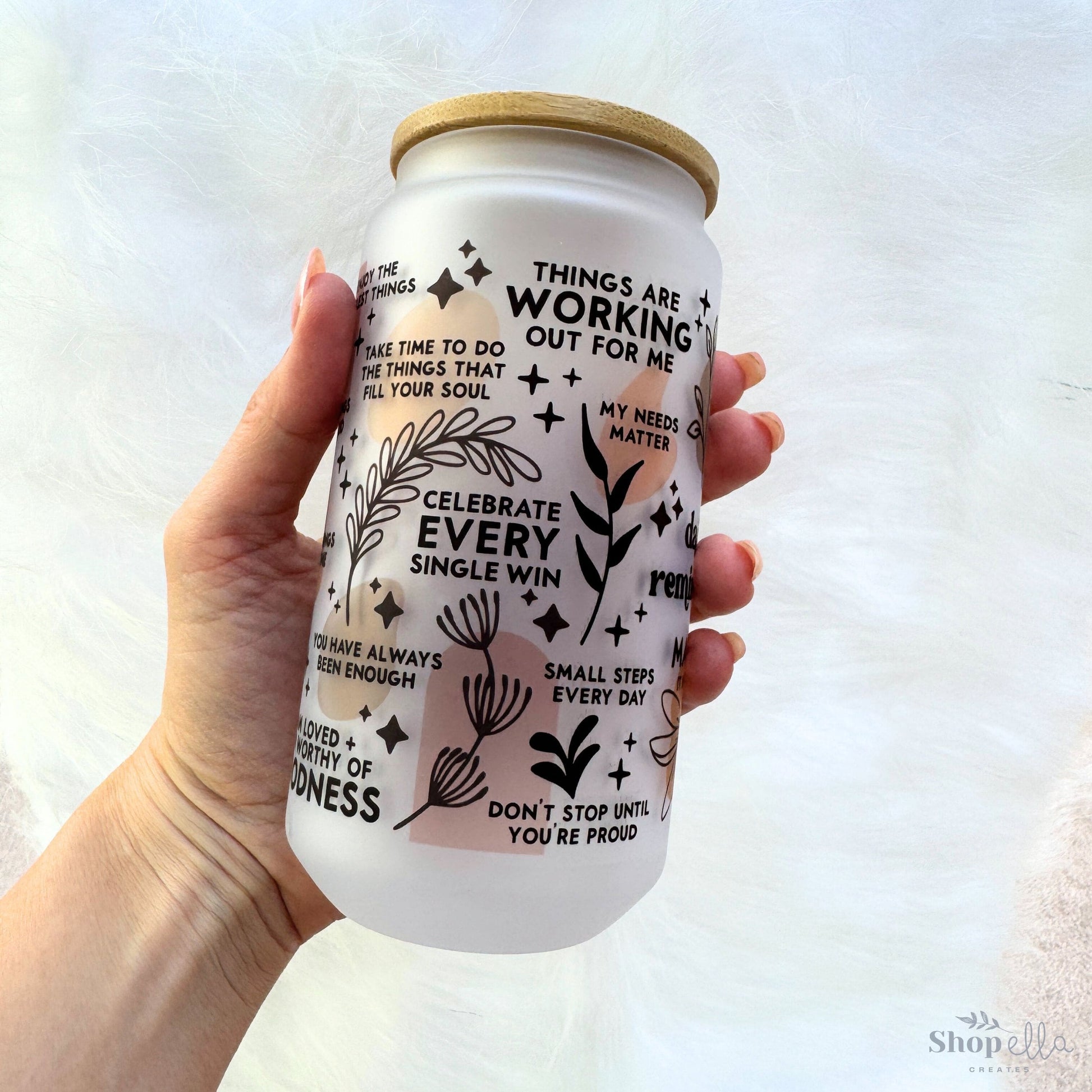 a hand holding a can of beer with words on it