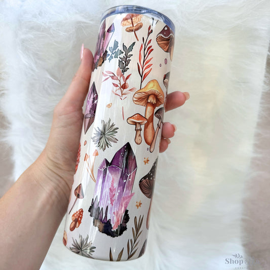 a person holding a cup with a pattern on it