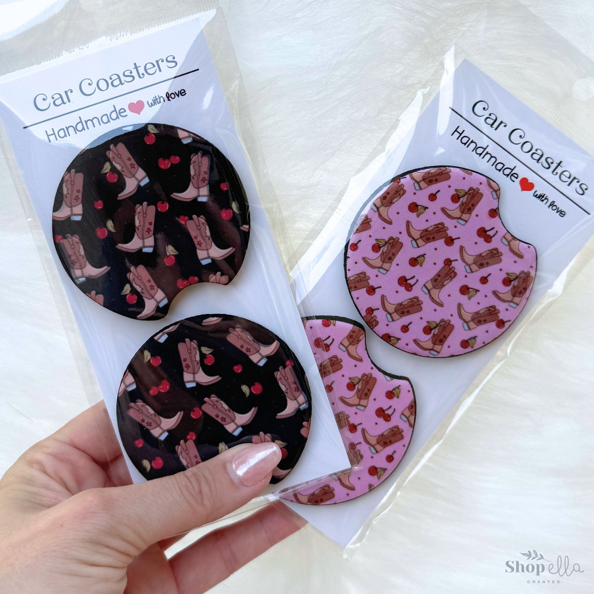 a hand holding a package of car coasters