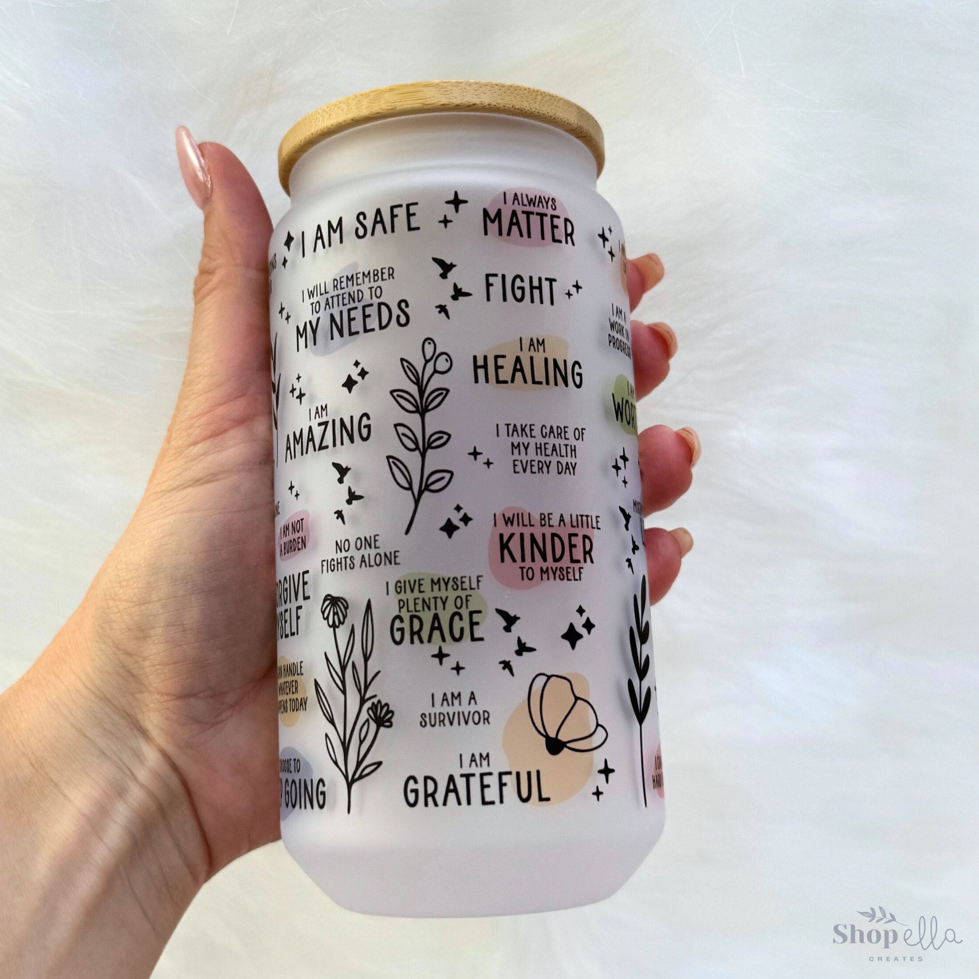 a hand holding a white can with writing on it