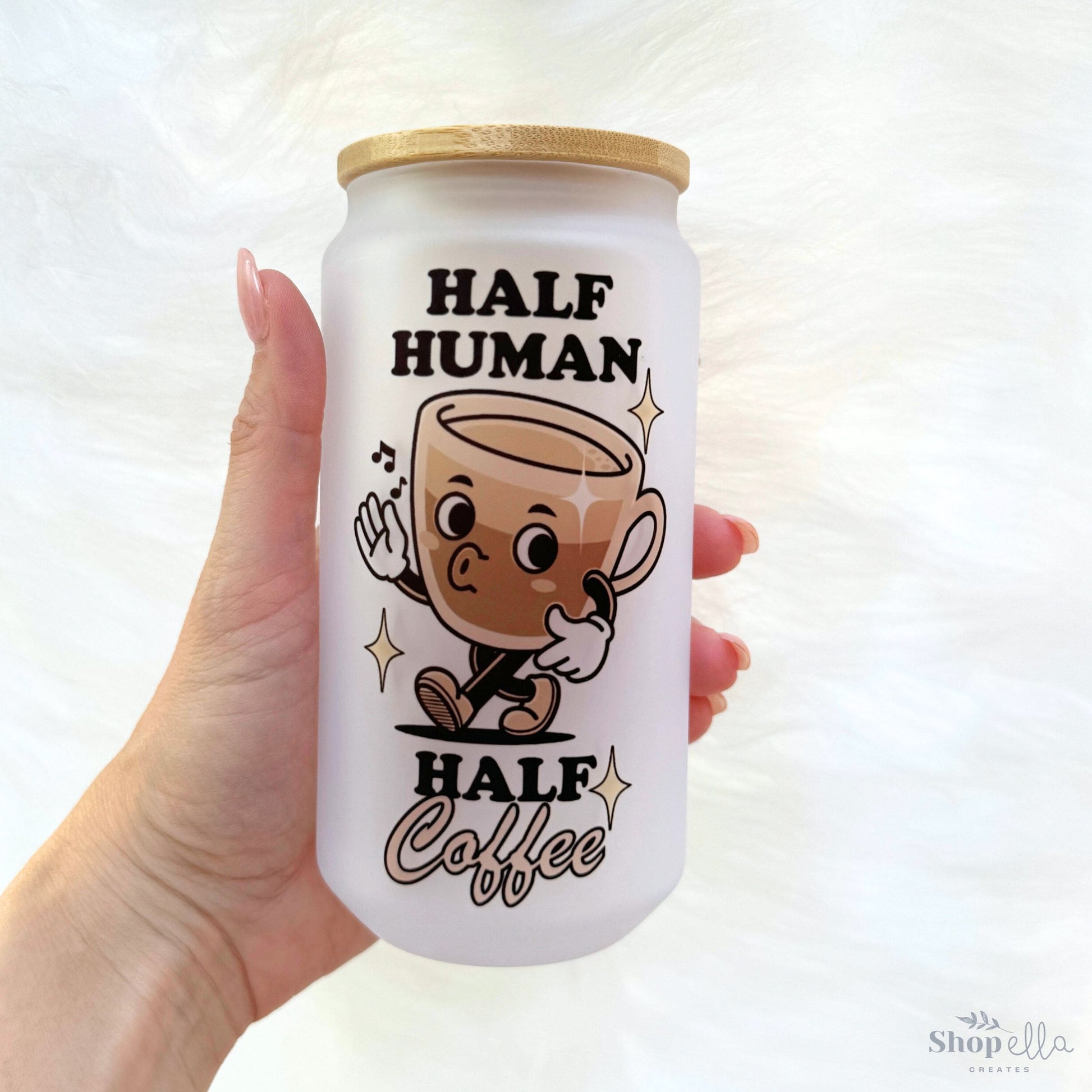 a hand holding a can of half human half coffee