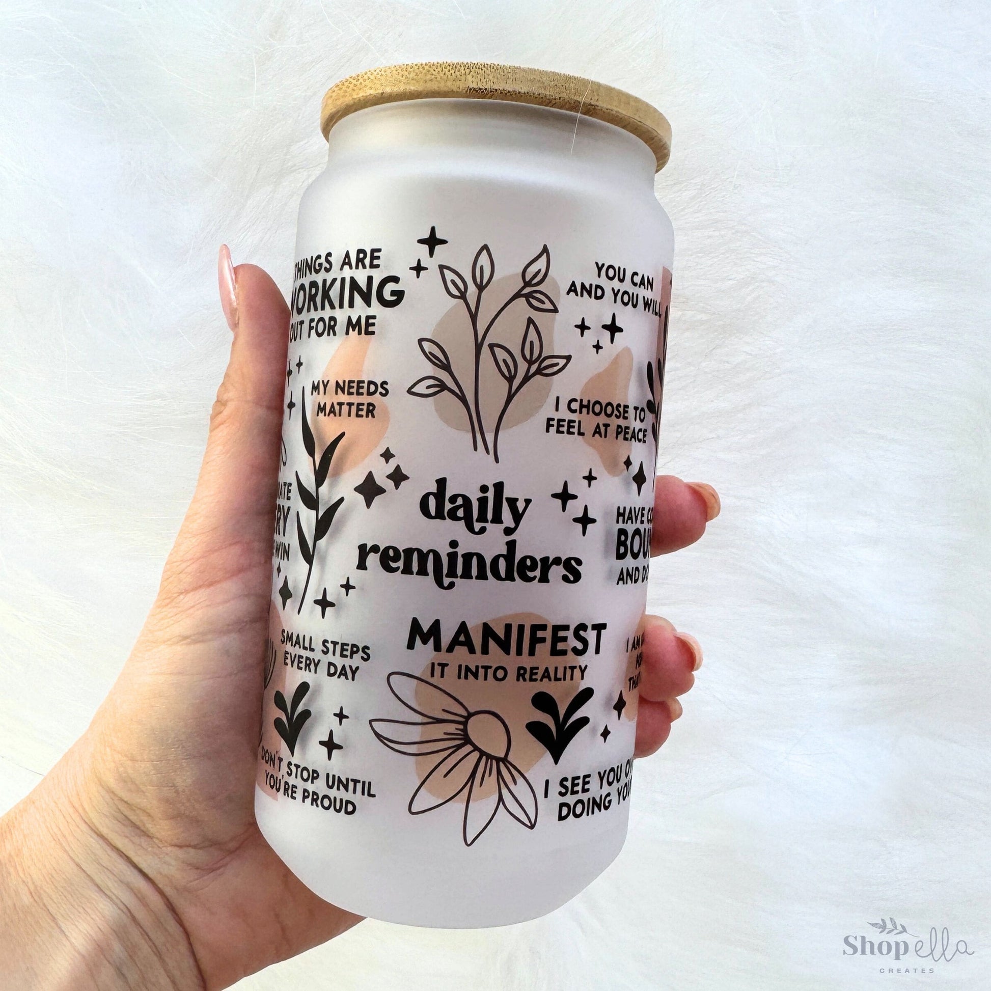 a hand holding a white can with words on it