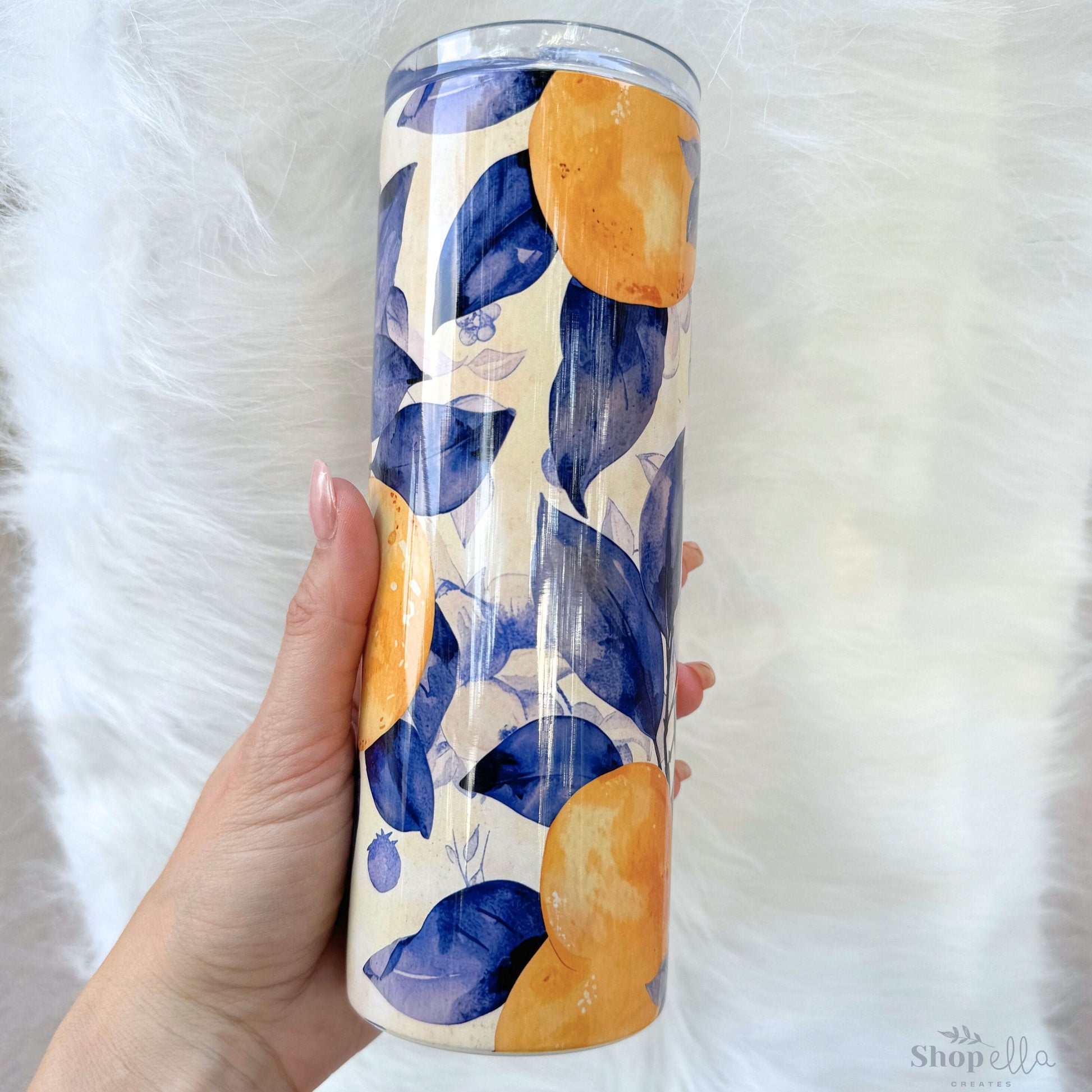 a hand holding a blue and yellow water bottle