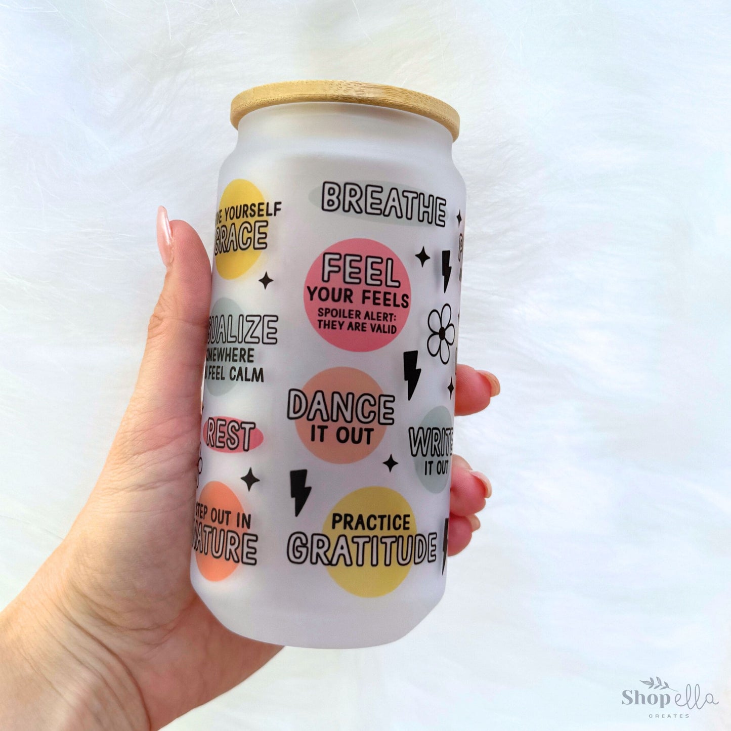 a hand holding a can of drink with words on it