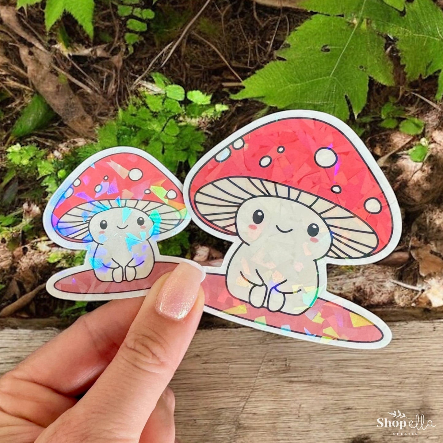 a hand holding a sticker with a mushroom on it