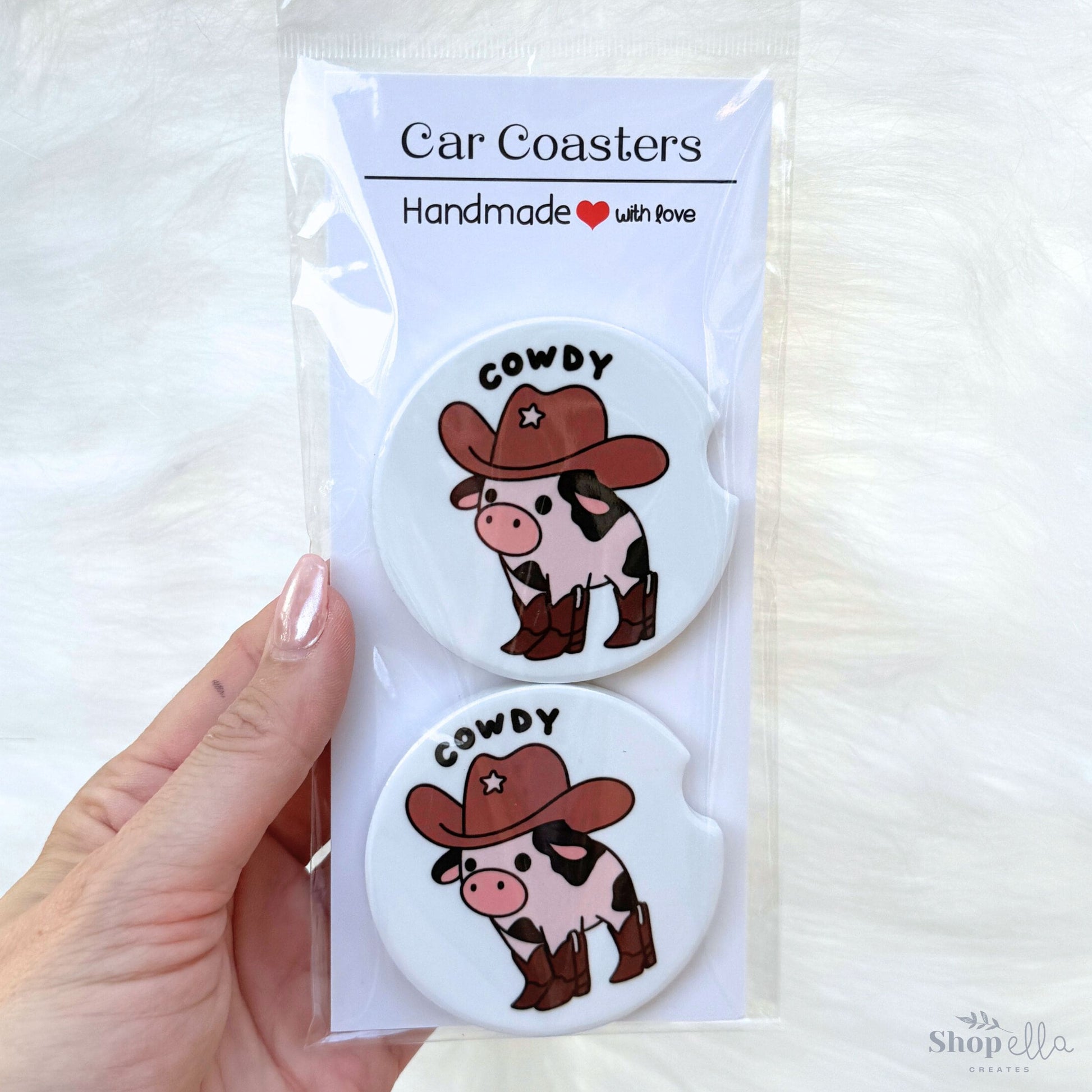 a package of two cowdy car coasters cowboy cow