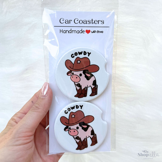 a package of two cowdy car coasters cowboy cow